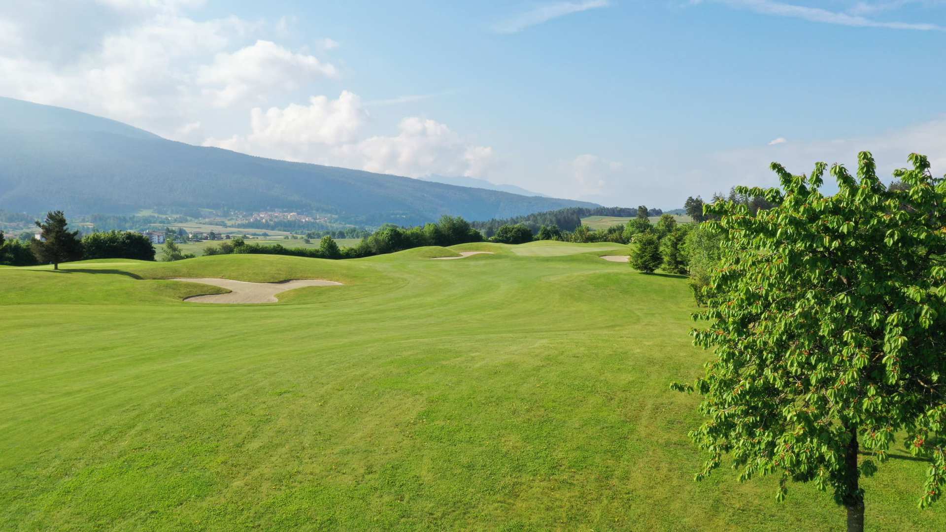 Some holes at Dolomiti Golf Club open onto wide, expansive landscapes with beautiful views