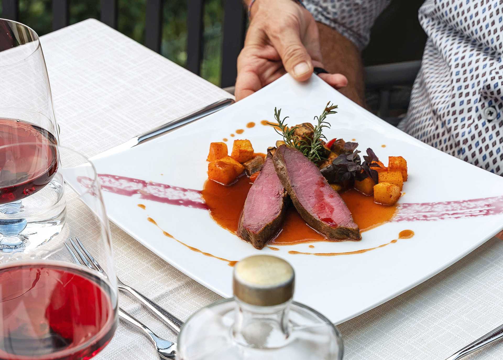 The main course, veal loin with potatoes and a delicate sauce, is served.