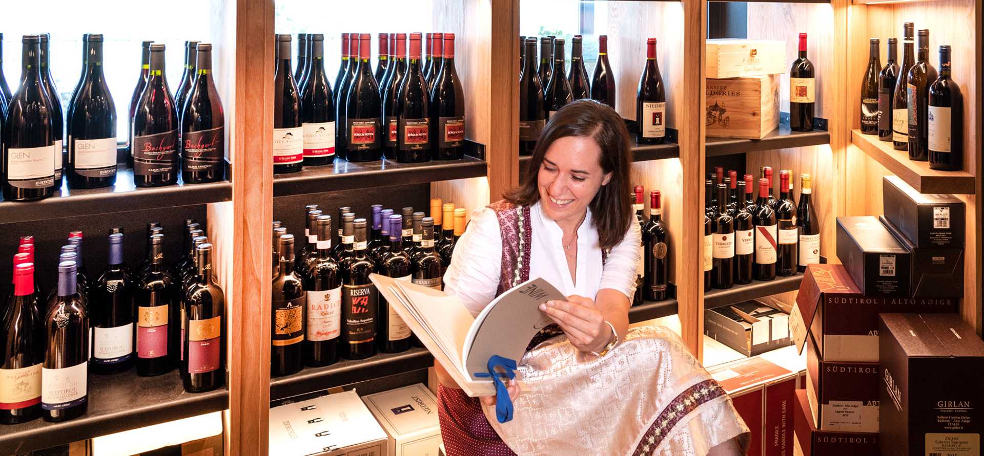 Christa (sommelier) in the wine cabinet