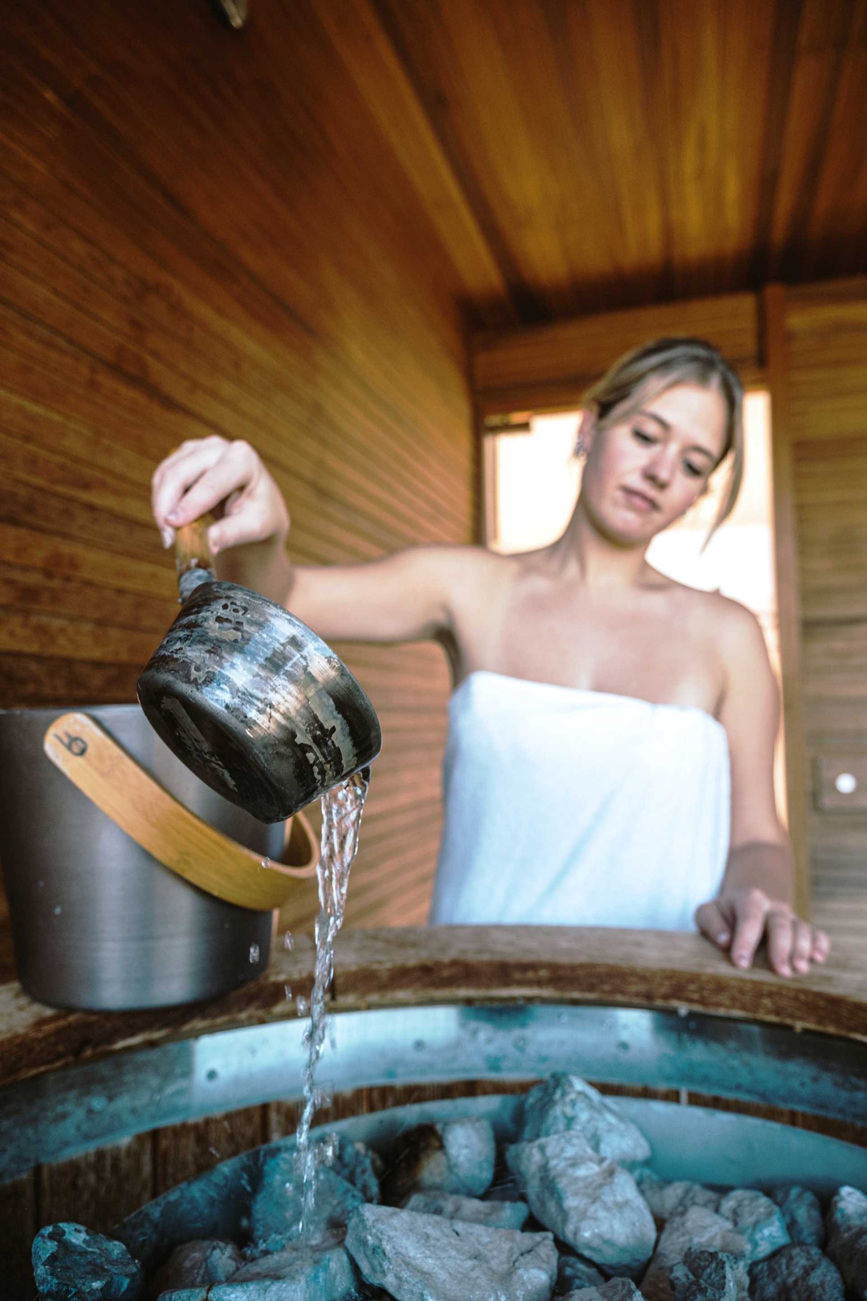 A woman is giving herself a sauna infusion.